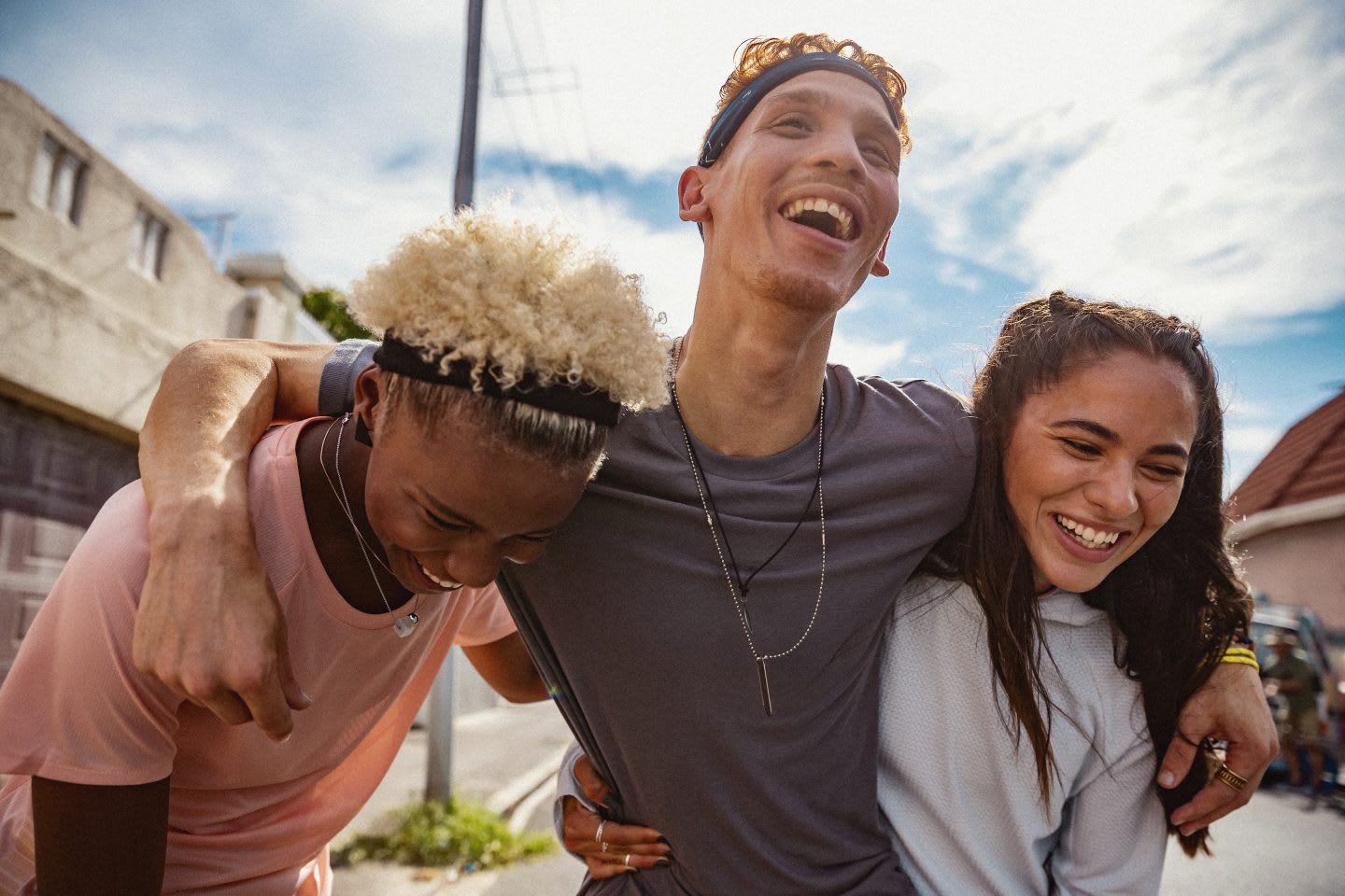 three smiling people in each others arms, Leadership