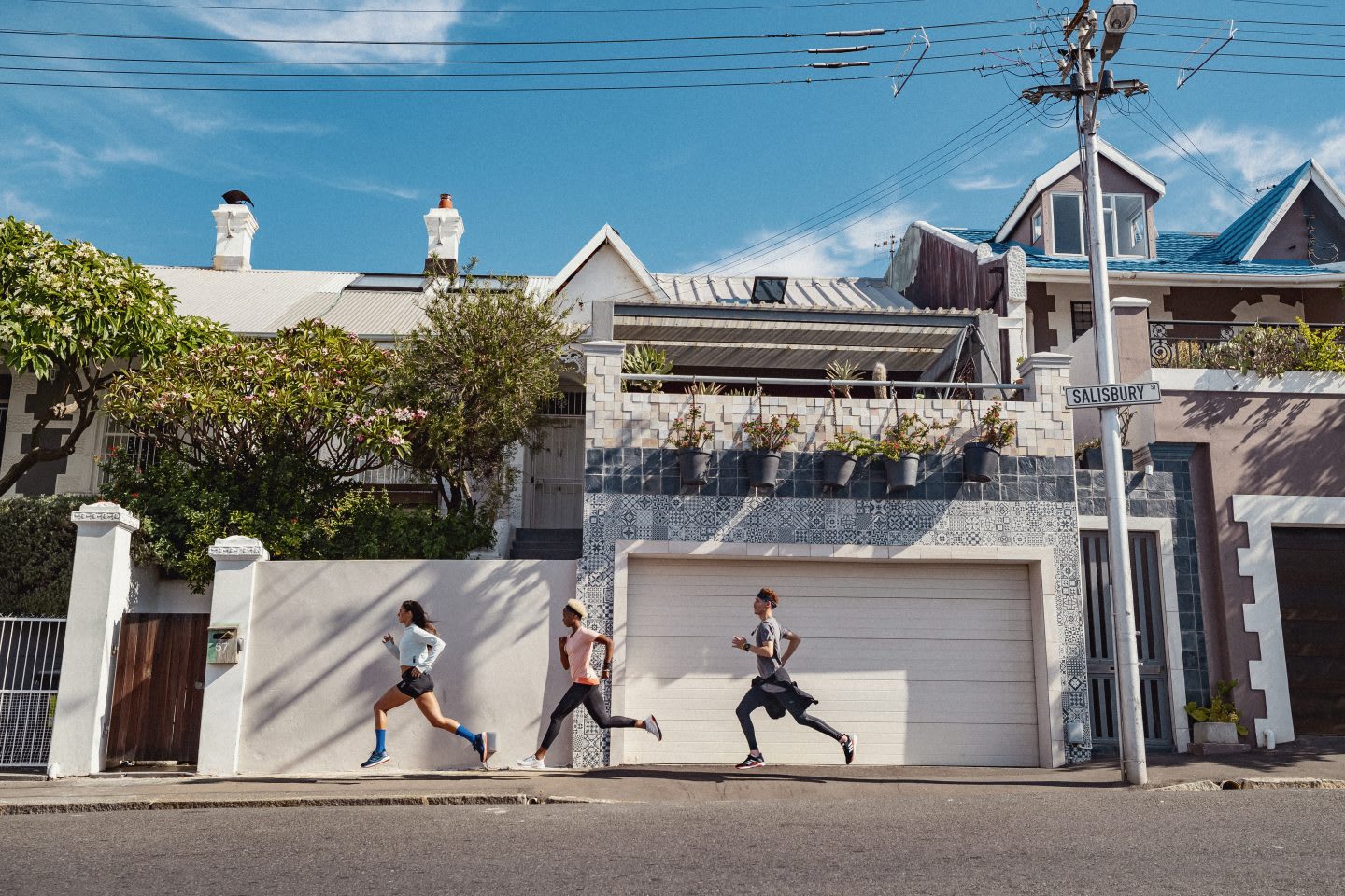 three people running down a road, Leadership
