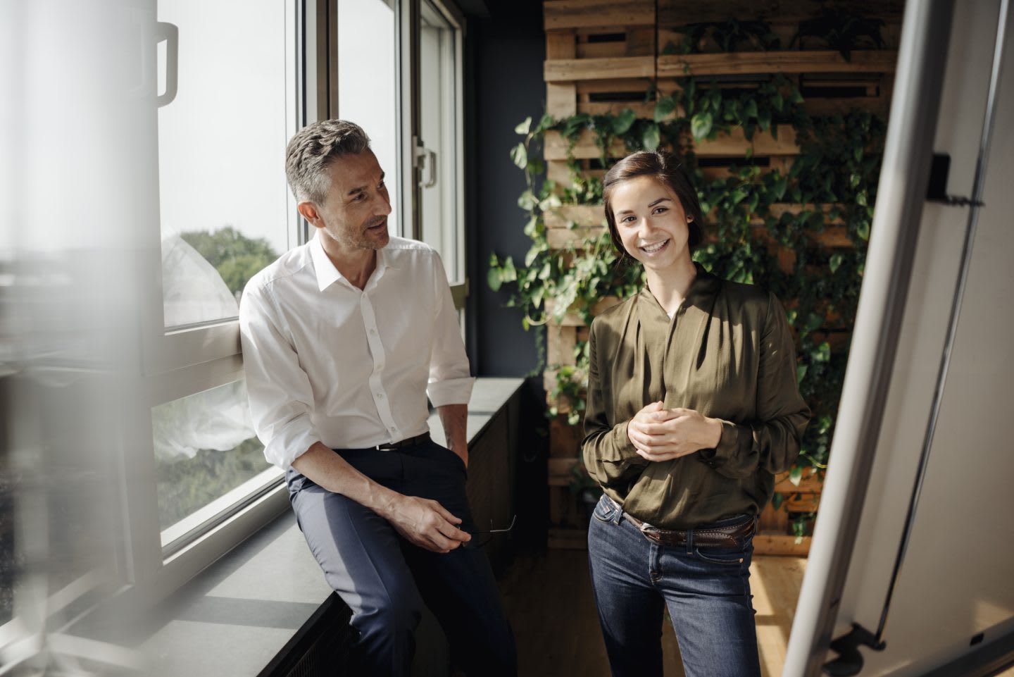 Businessman and businesswoman working with flip chart in green office. motivate, athlete mindset, self-improvement, success at work, GamePlan A