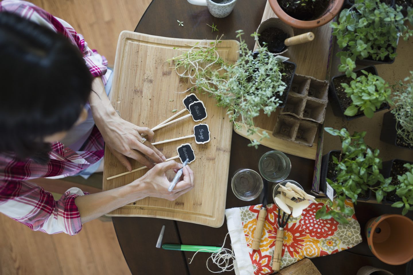 Woman preparing plant markers at table. avoid plastic, sustainability, habits and routines, inspiration, GamePlan A.