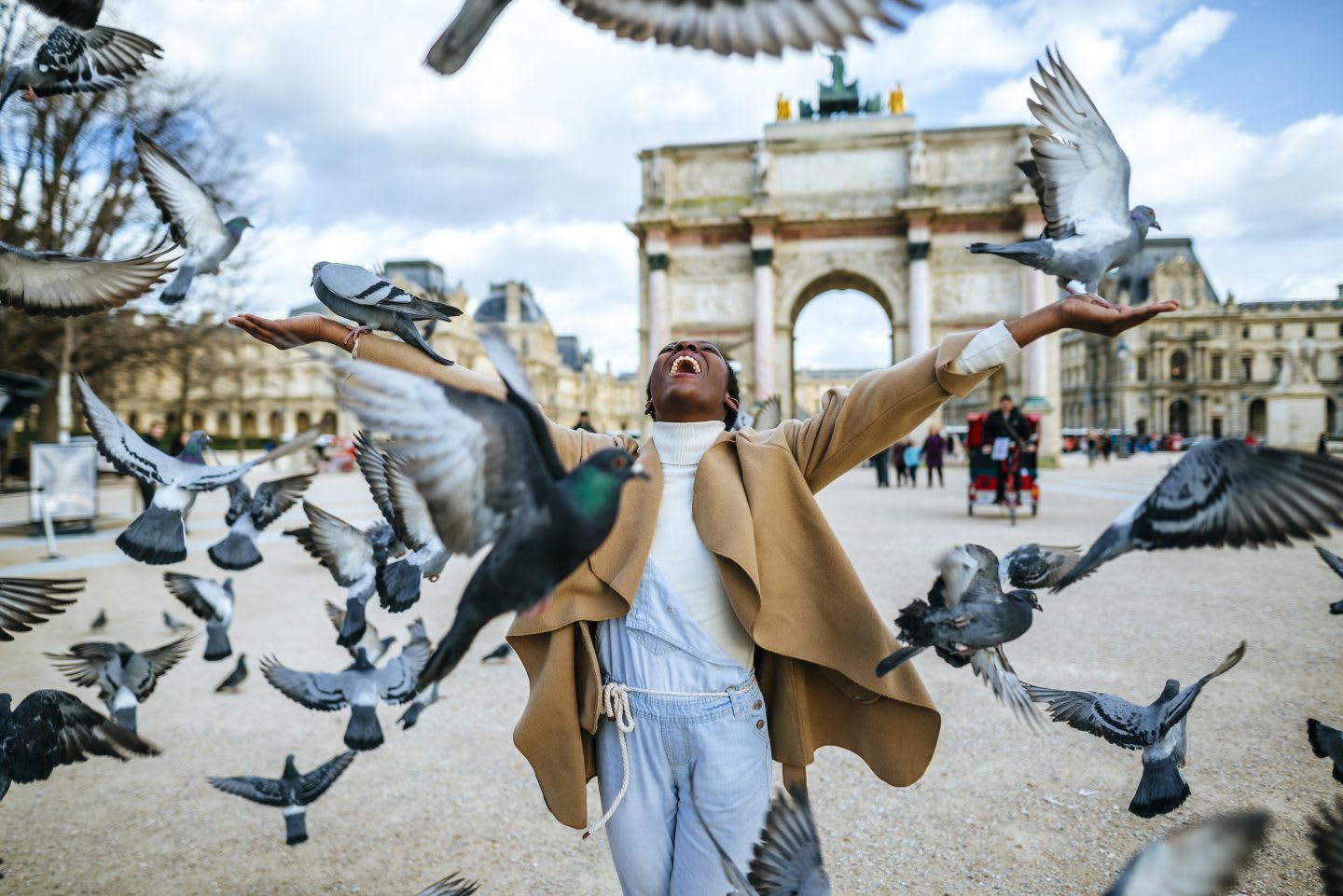 woman celebrating with doves flying around her