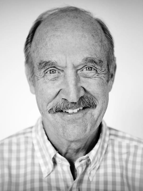 Stan Smith smiles as he looks into the camera