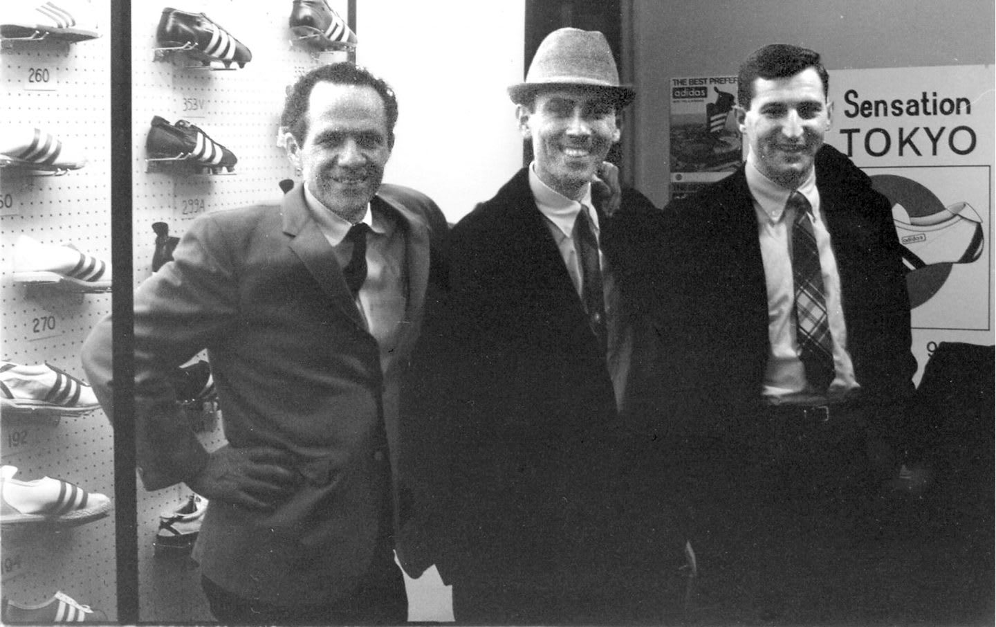 Black and white phtot of Horst Dassler with brothers Clifford and Chris Severn at the 1965 National Sporting Goods Association show in Chicago.