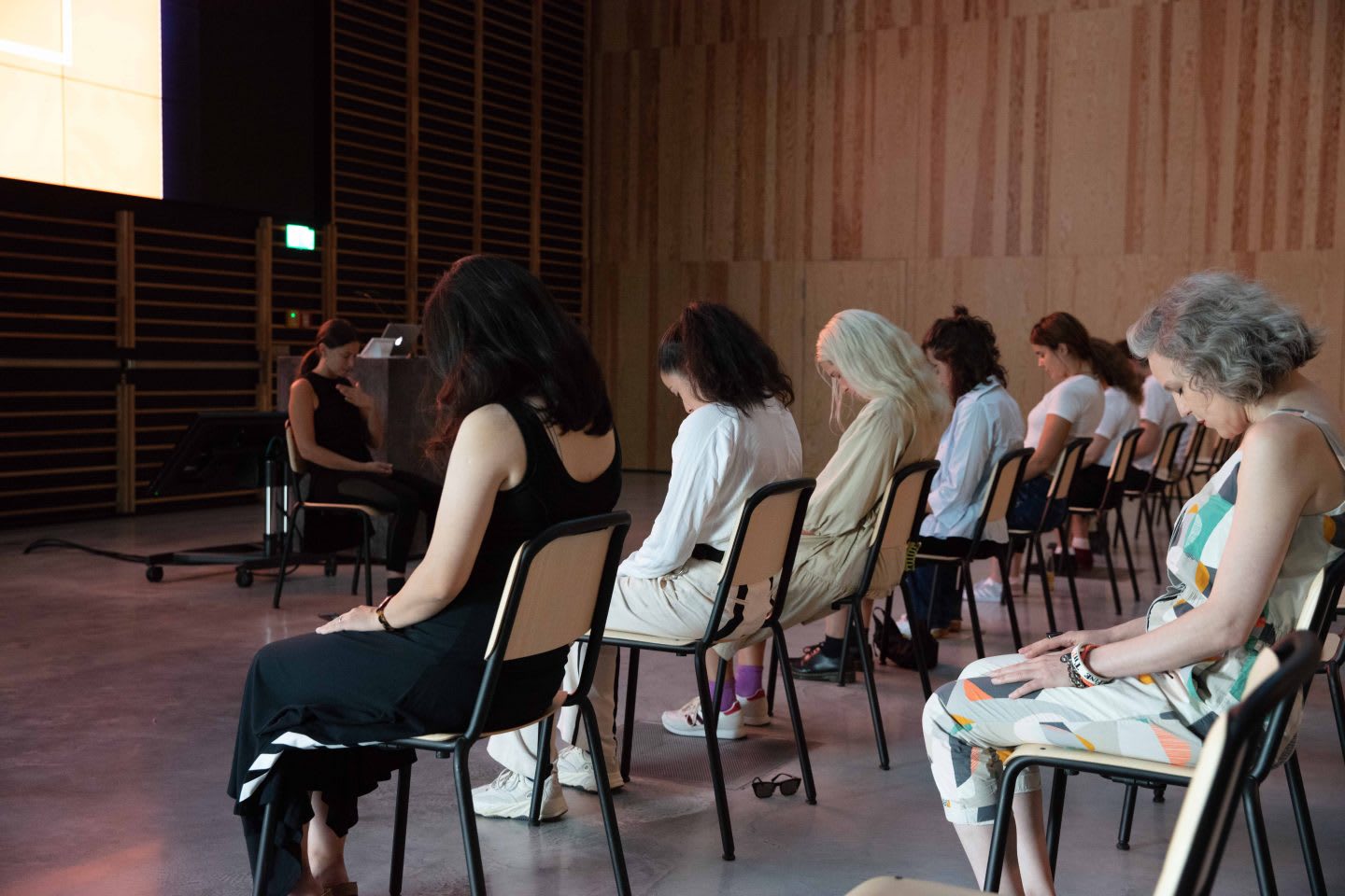 Group practicing seated yoga. GamePlanA, BusinessWithPurpose