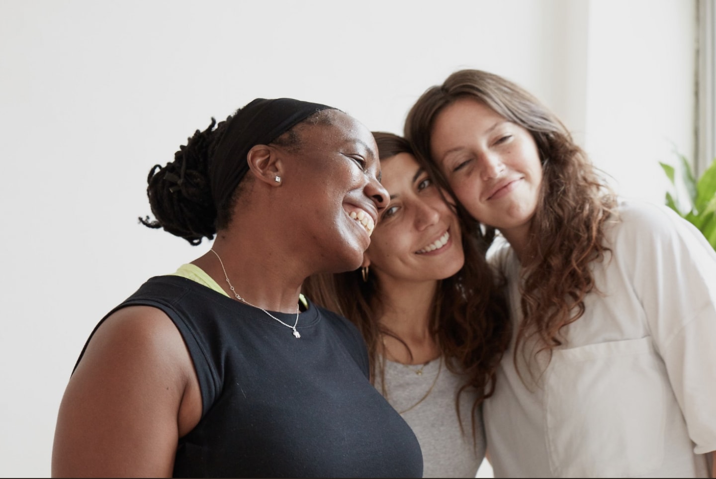Group of women smiling at the camera after a Yoga session in Aby Nolan's studio.
