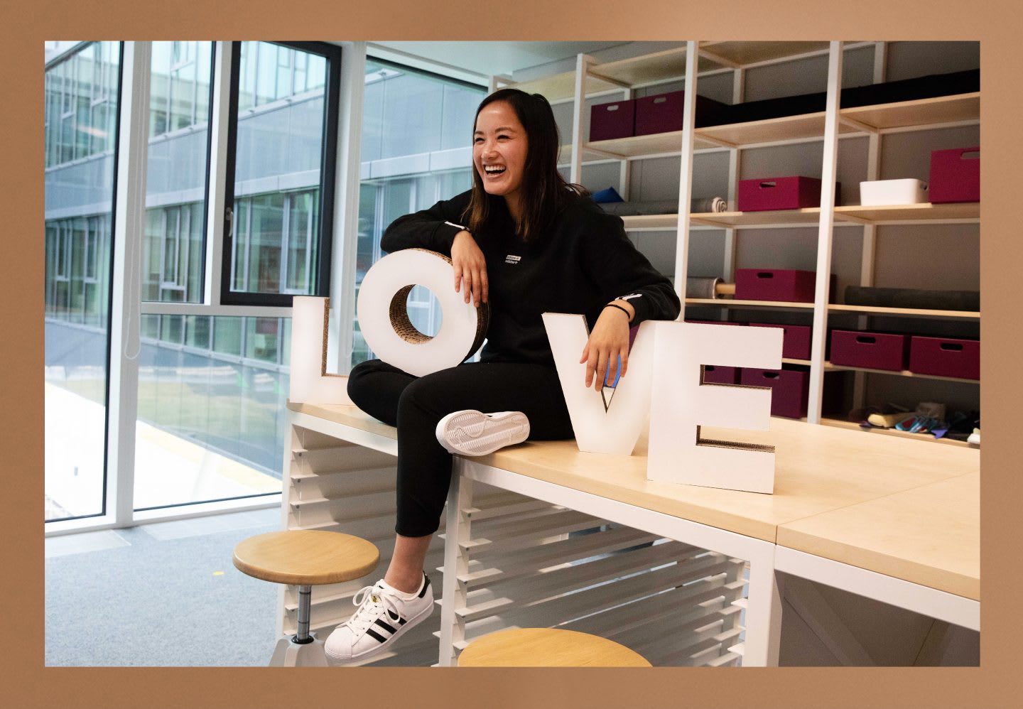 Thui Bui holds a sign with love letters and a wide smile. Be unique, Uniqueness, Personal growth, GamePlanA