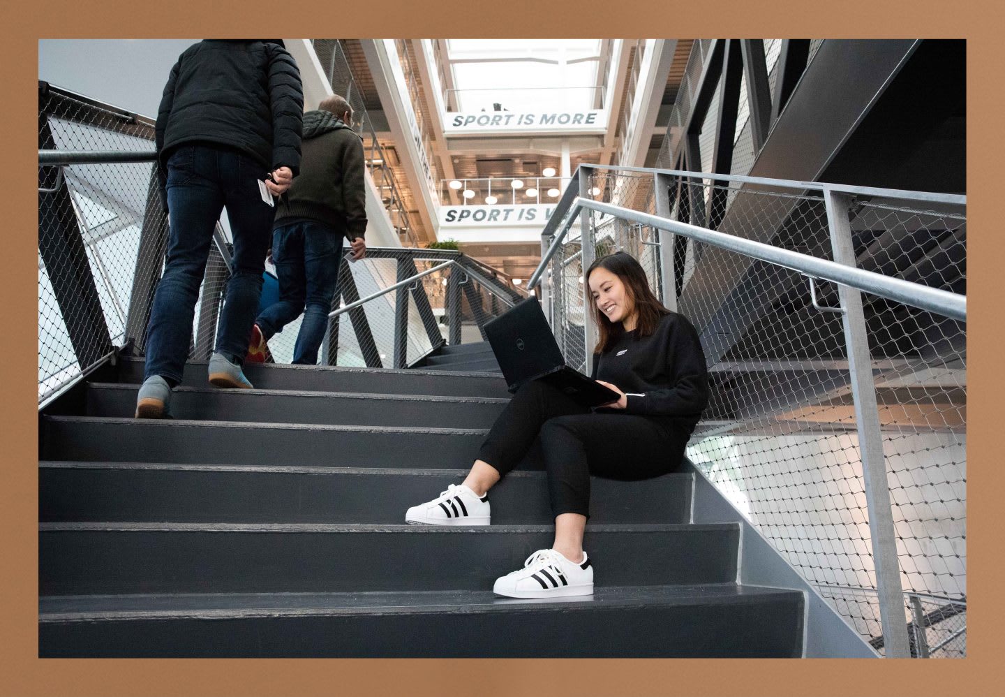 Thui Bui sitting in the starts of the adidas HQ working. Be Unique, self development, personal growth, GamePlanA