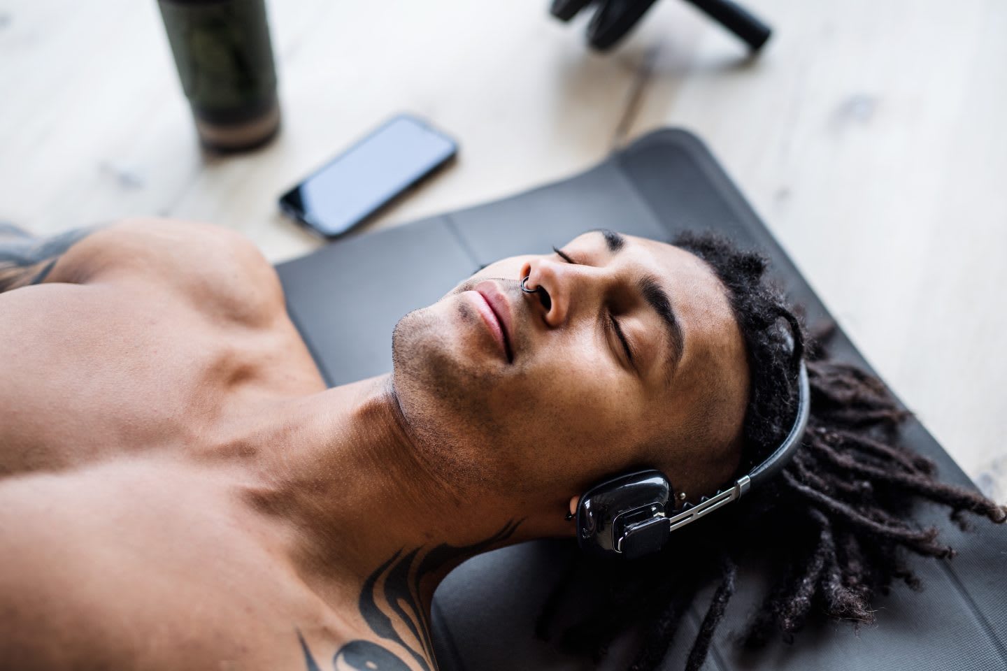 Man with headphones doing exercise at home, relaxation, calm, focus, music, GamePlan A