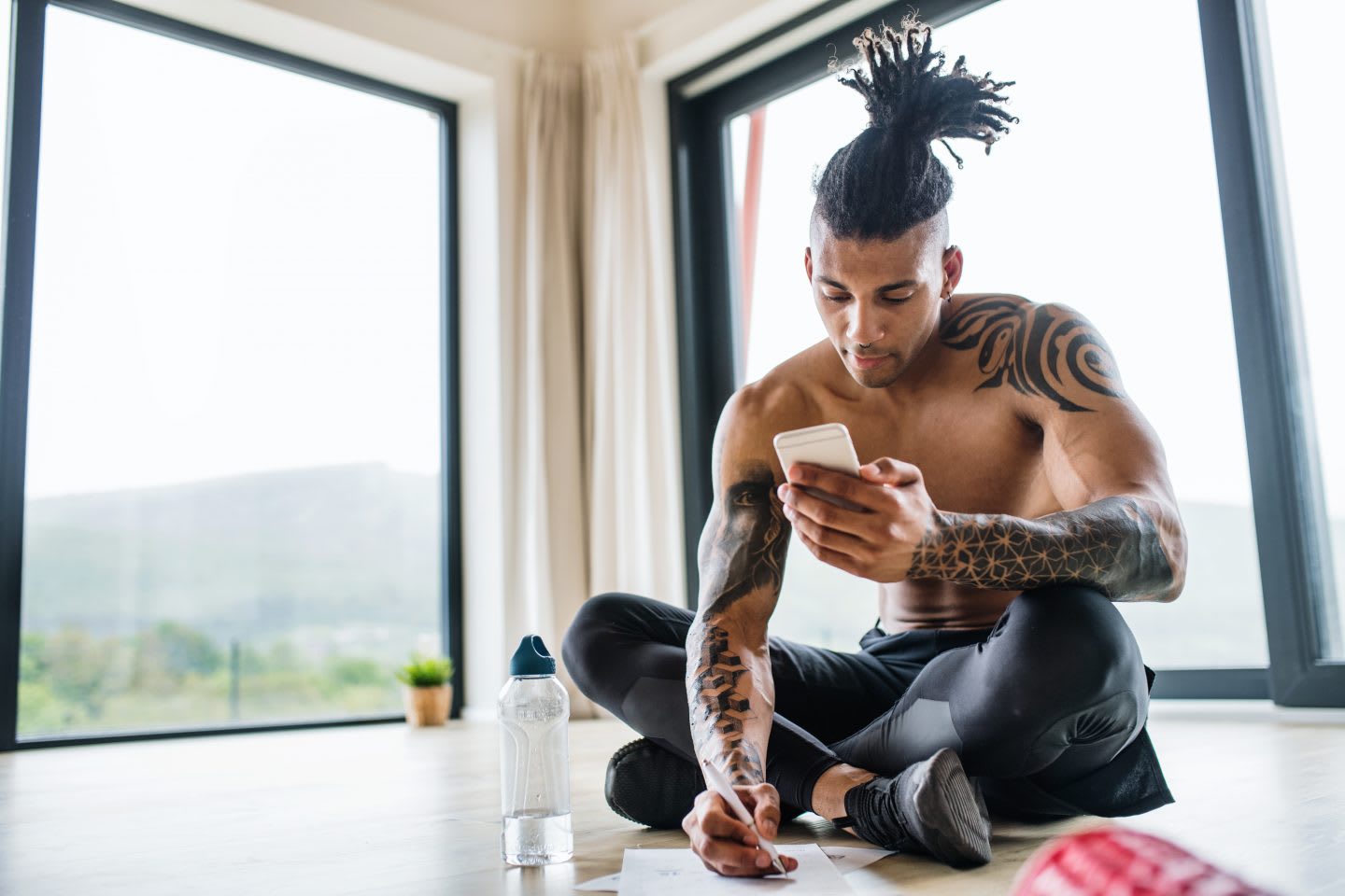 Young man tracking progress and planning routines, structure, motivation, focus, writing, mindset, GamePlan A