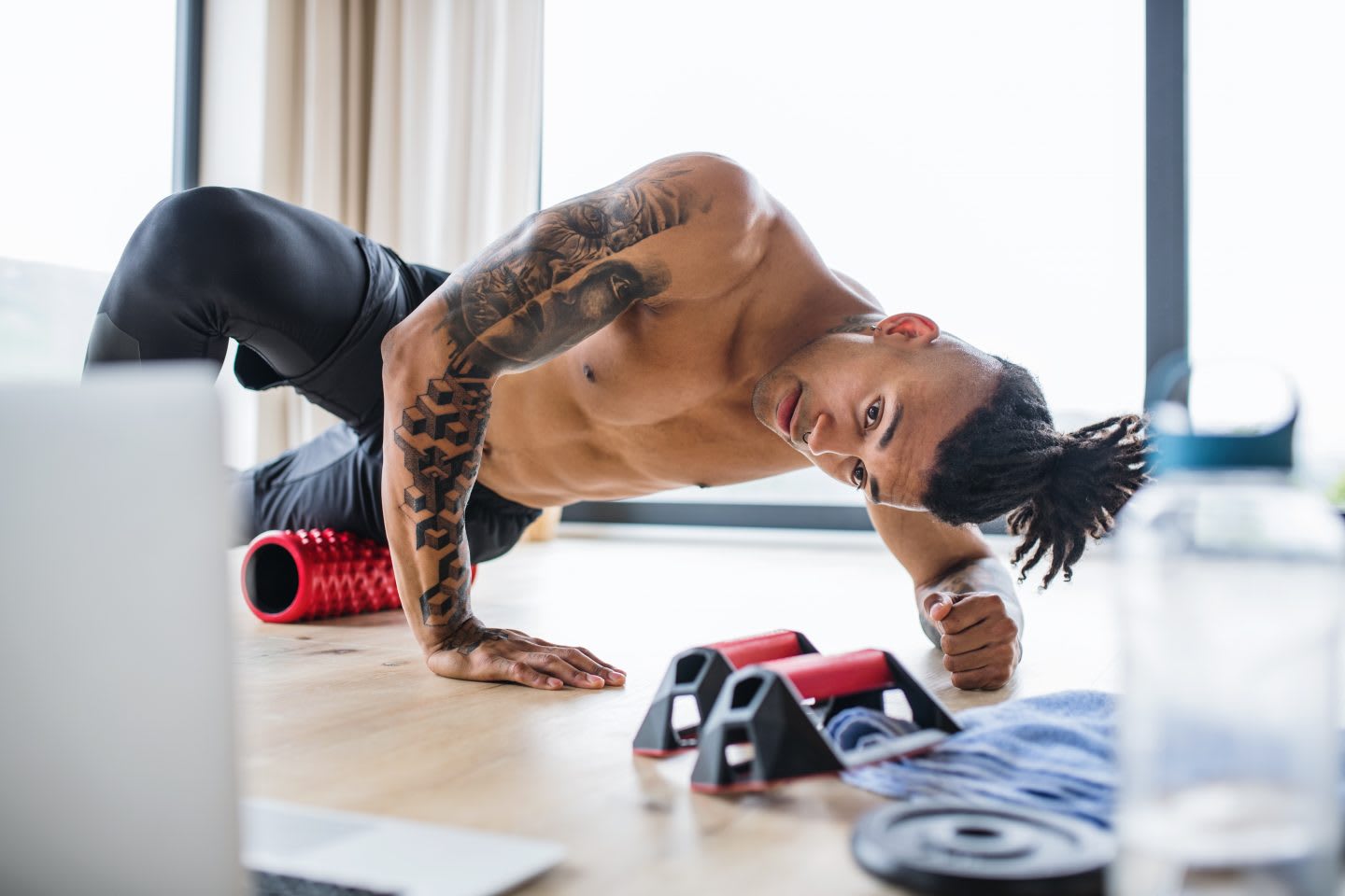 Man with laptop doing exercise at home, fitness, health, exercise, foam rolling, stretching, GamePlan A