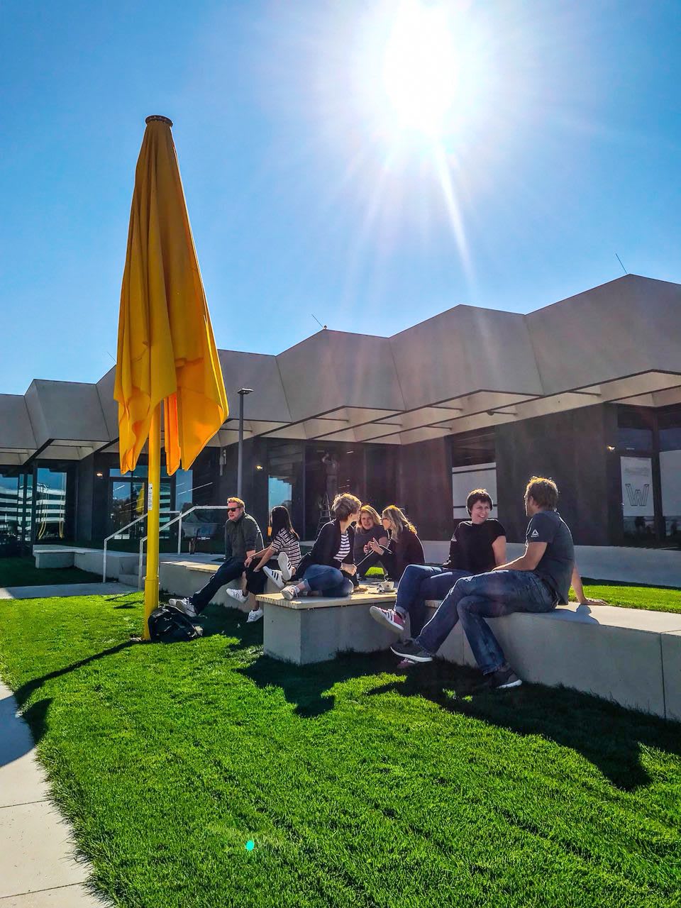 colleagues enjoying the sun outside near Halftime building at World of Sports, adidas, team, colleagues, teamwork, collaboration, GamePlan A