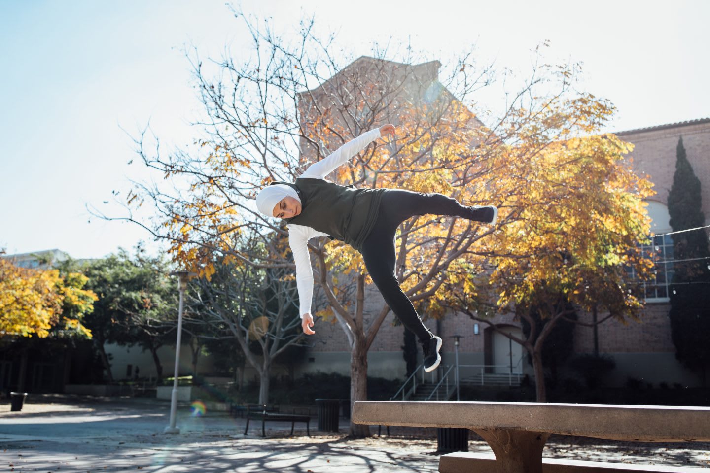 Girl doing flip in the air on a sunny day, parkour, sports, action, fitness, exercise, Sara Mudallal