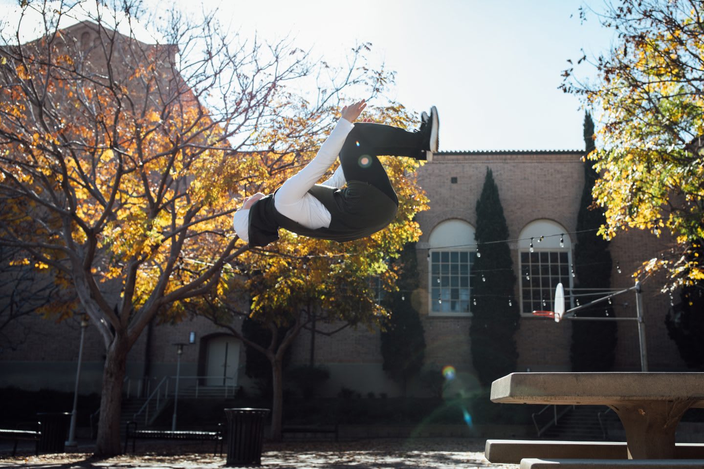 Woman doing backflip in the air on a sunny day, parkour, action, sports, active, athlete, Sara Mudallal