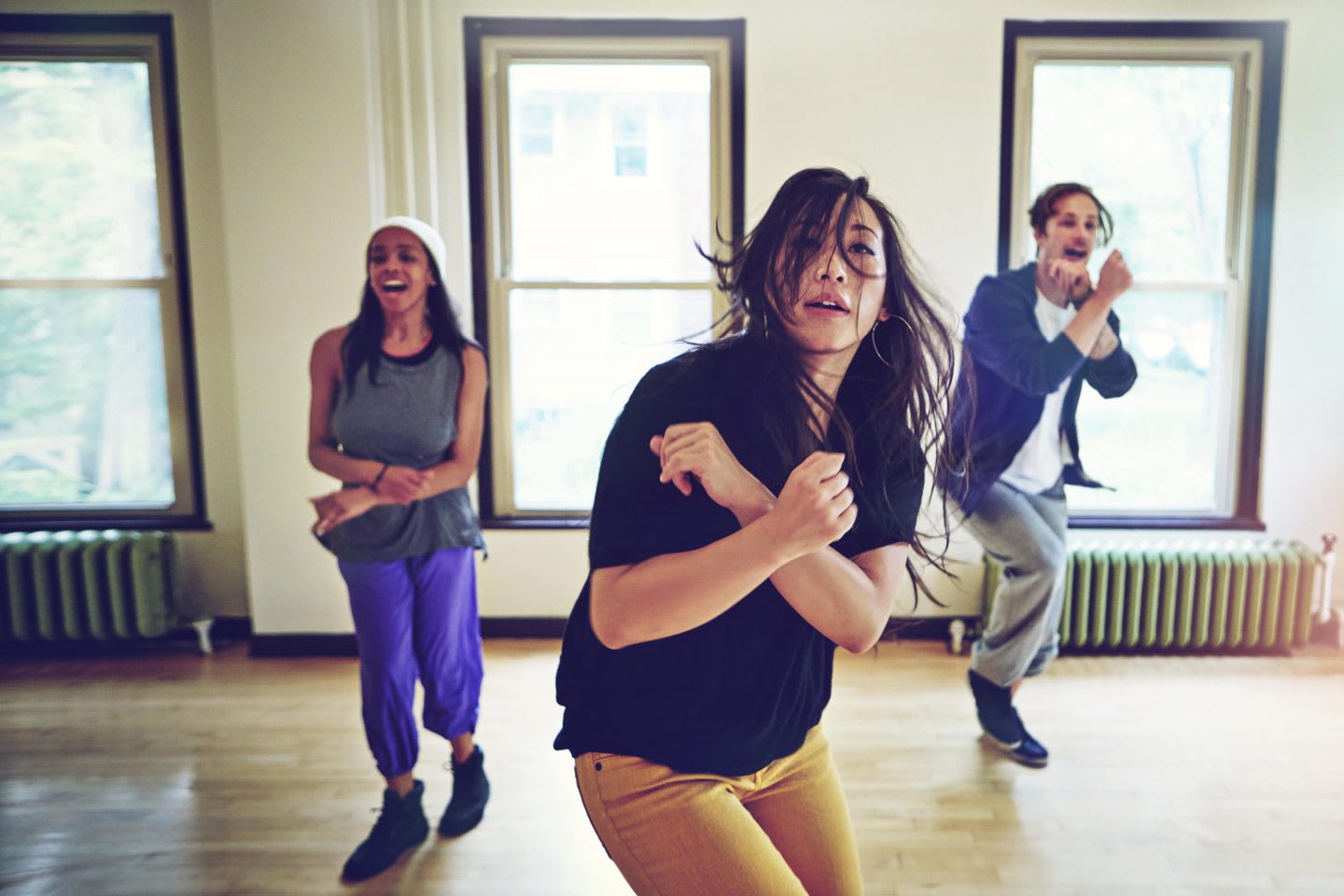 Three people dancing in a dance studio, friends, music, movement, active, fun