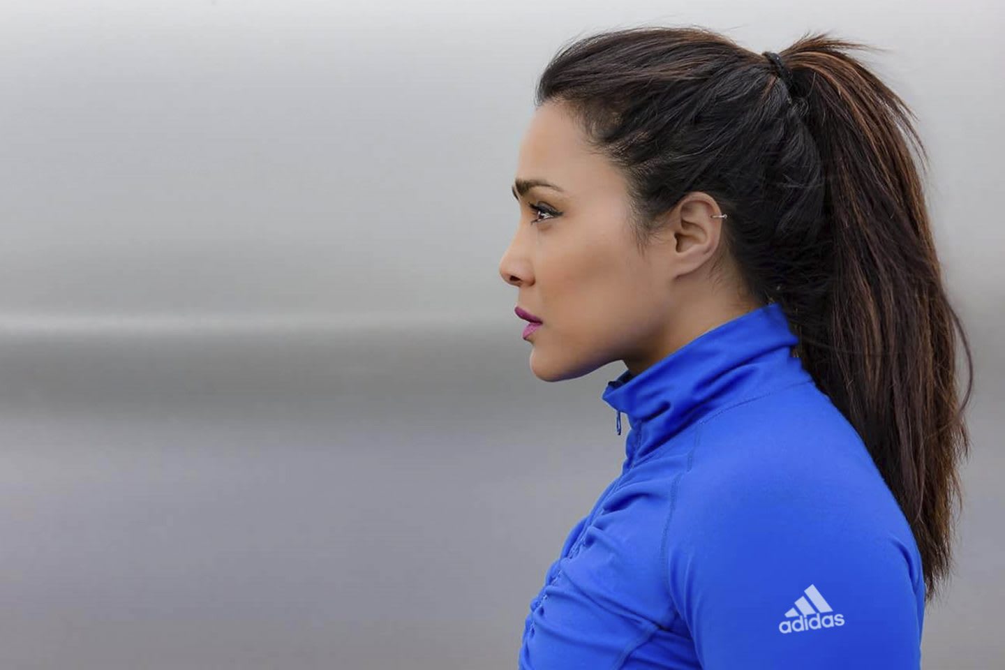 Woman staring out into space wearing sports gear, adidas, sports, fitness, Nazia Khatun, moody, grey