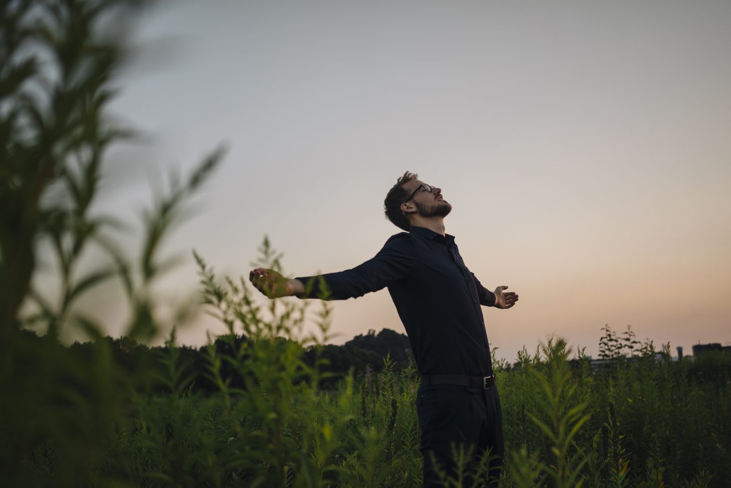 Man standing in rural field at sunset, stretching, relaxing, field, man, sky, GamePlan A
