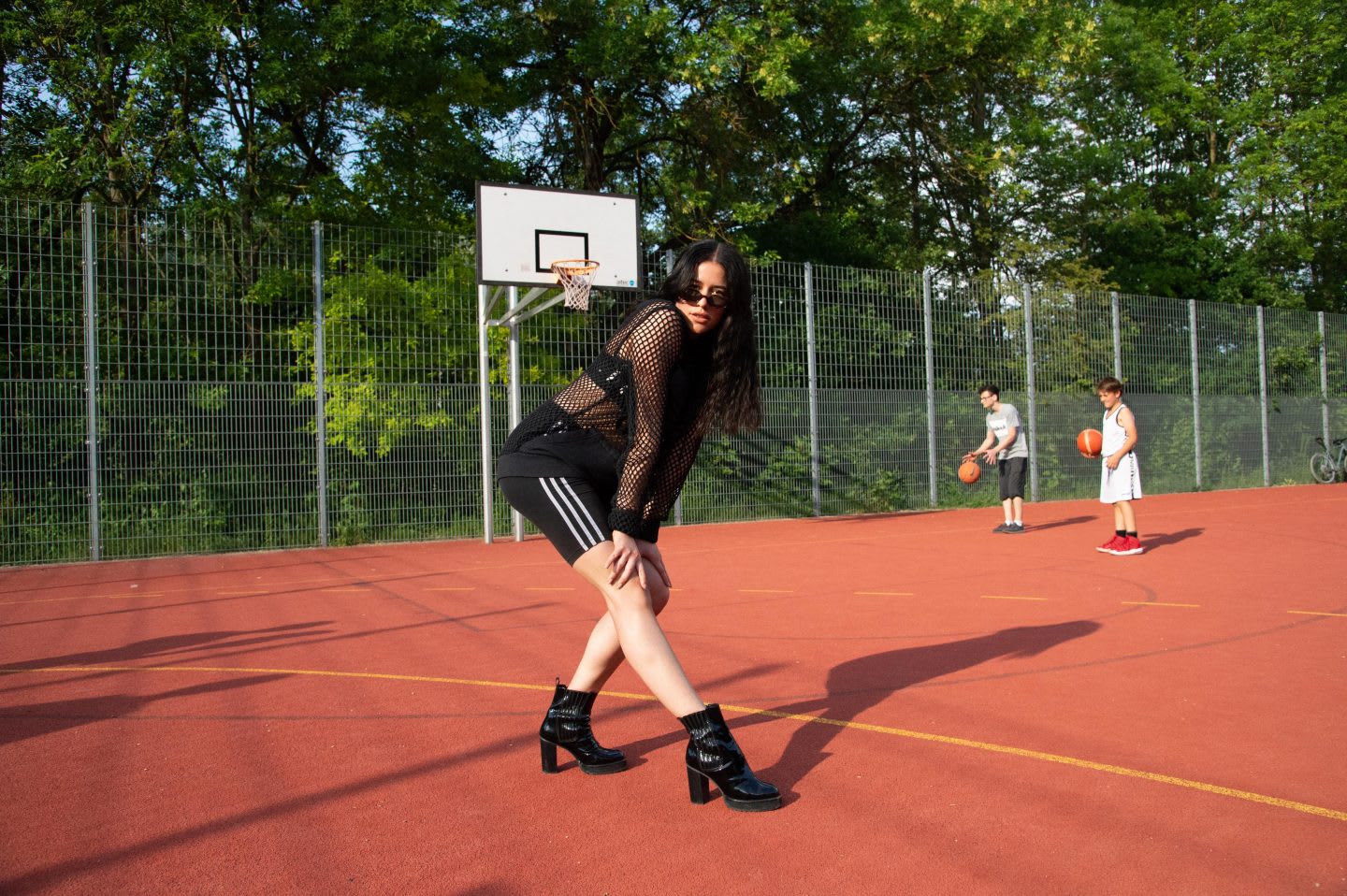 Girl wearing black tights and black boots posing on a basketball court, voguing, vogue, photography, attitude, posing, adidas, employees, confidence, GamePlan A