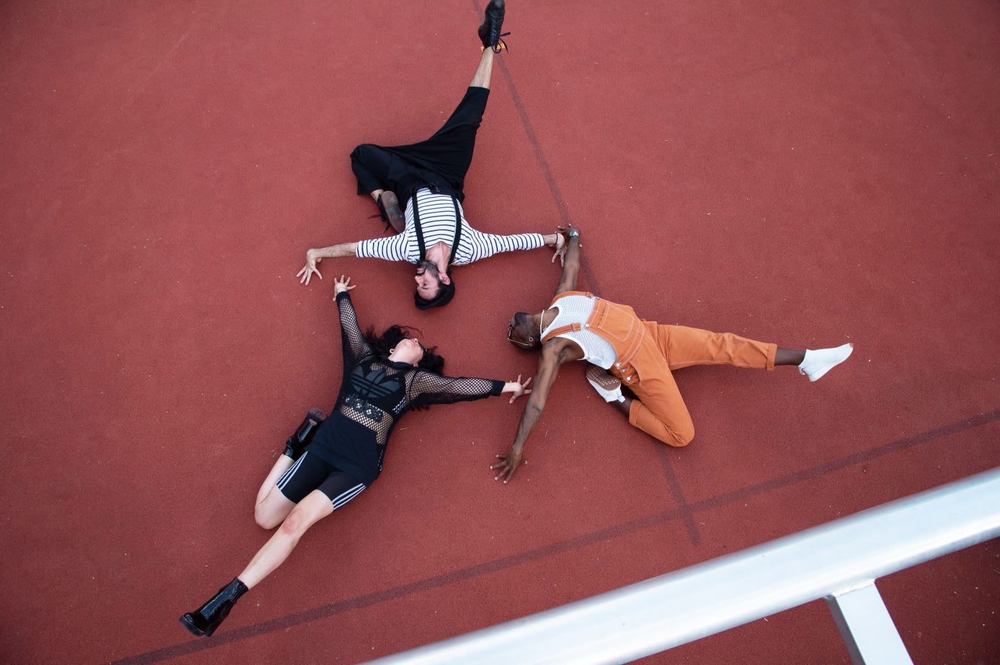 Two men and one woman lying on the ground with dramatic poses, voguing, vogue, photography, attitude, posing, adidas, employees, confidence, GamePlan A
