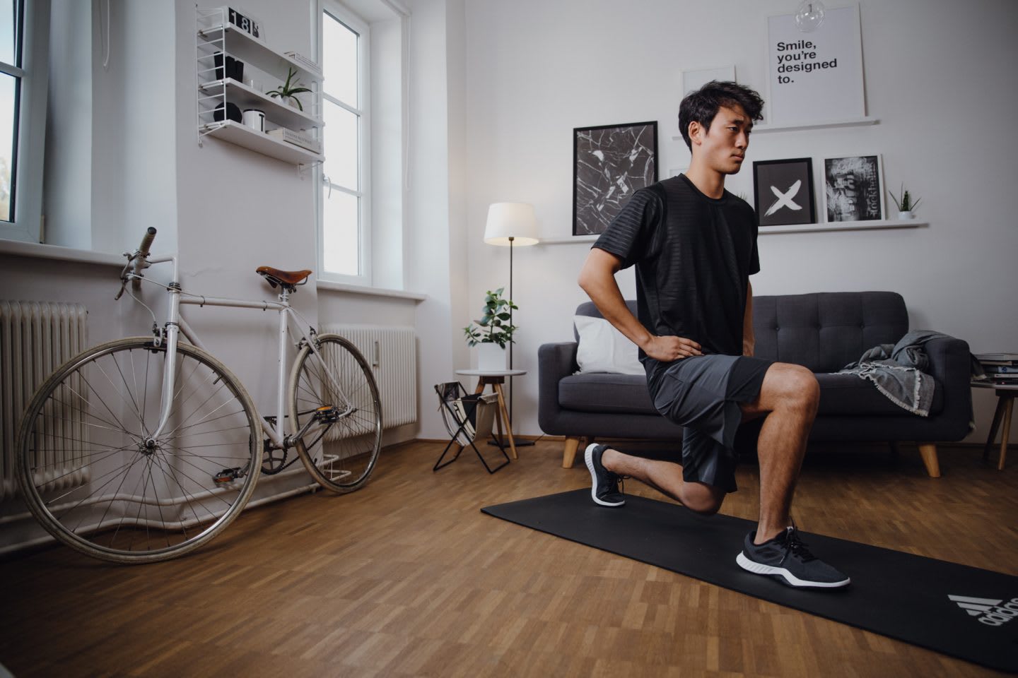 Man wearing dark t-shit exercising at home in living room, WFH, fitness, workout, exercise, training, adidas, sports