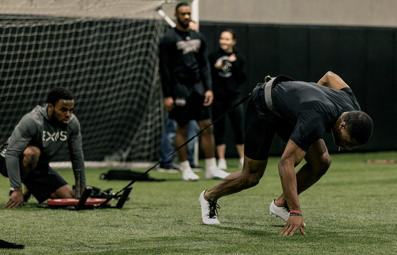 Person training in an indoor field, strength, sport, exercise, EXOS, fitness, athlete