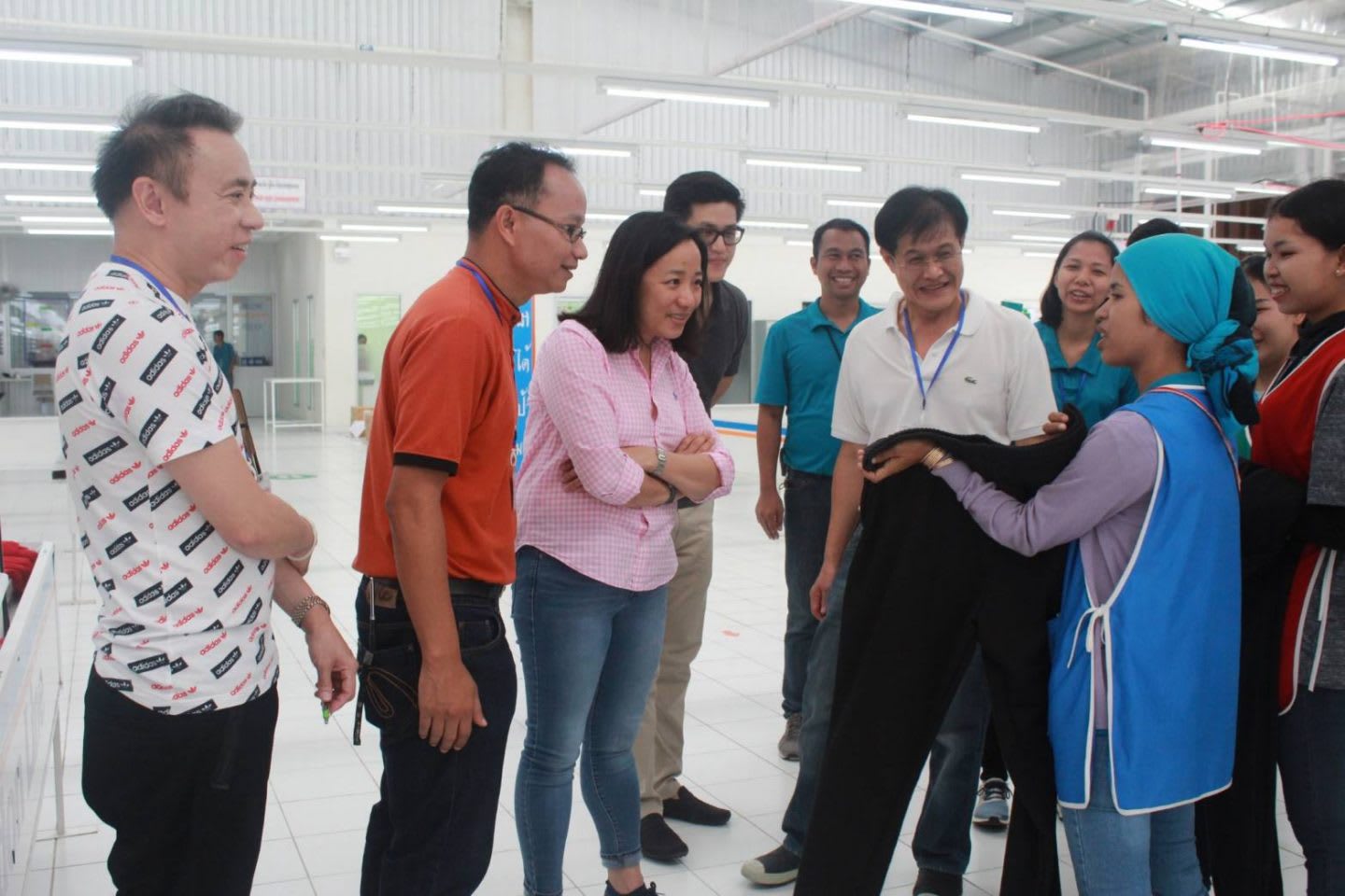 Group of people looking at a fabric from a worker in a factory, Hoa Ly, adidas, Sourcing, employee, Asia, Southeast Asia