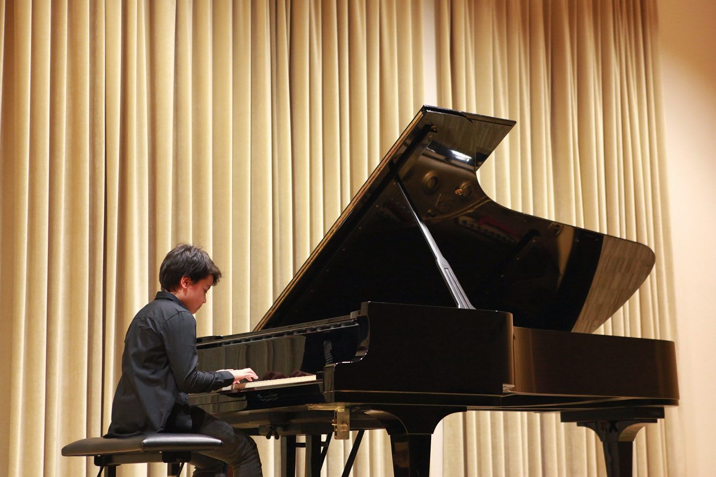 Young boy is playing grand piano at the school concert, child, learning, instrument, recital, music