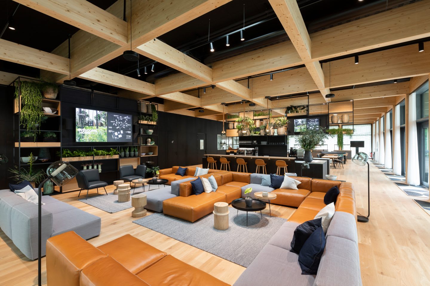 The indoor team area with lounge furniture, a bar and a TV inside the German national football teams base camp. Home Ground, football, teambuilding, adidas headquarters, GamePlan A.