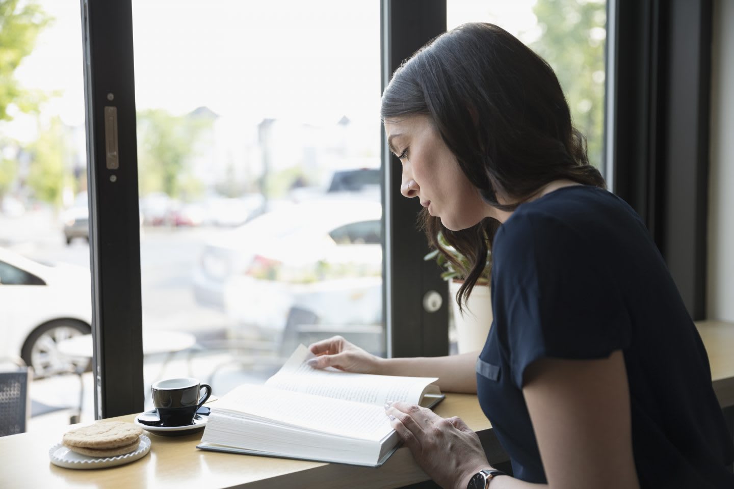 woman reading a book in a cafe. Reading, book, mindset, reading list,