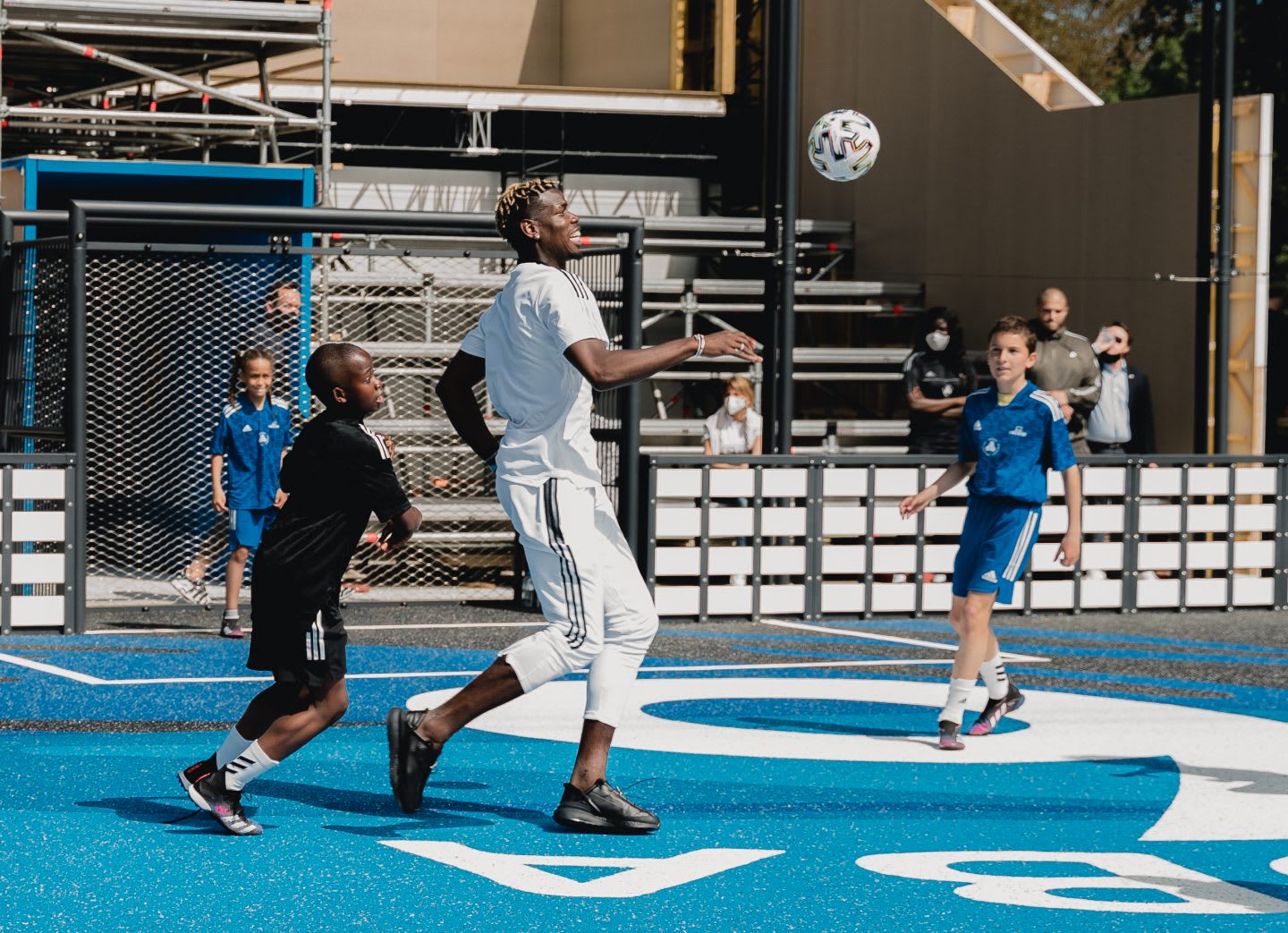 Pogba playing football with kids on his court. Football, france, kids, community, playing football