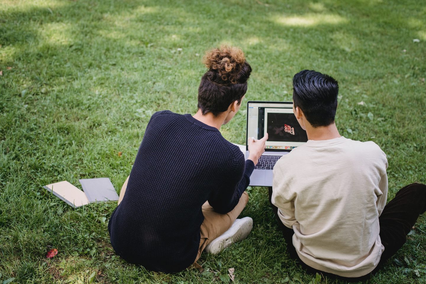 Students working on laptop together while sitting on the grass, laptop, collaboration, learning, friends, youth