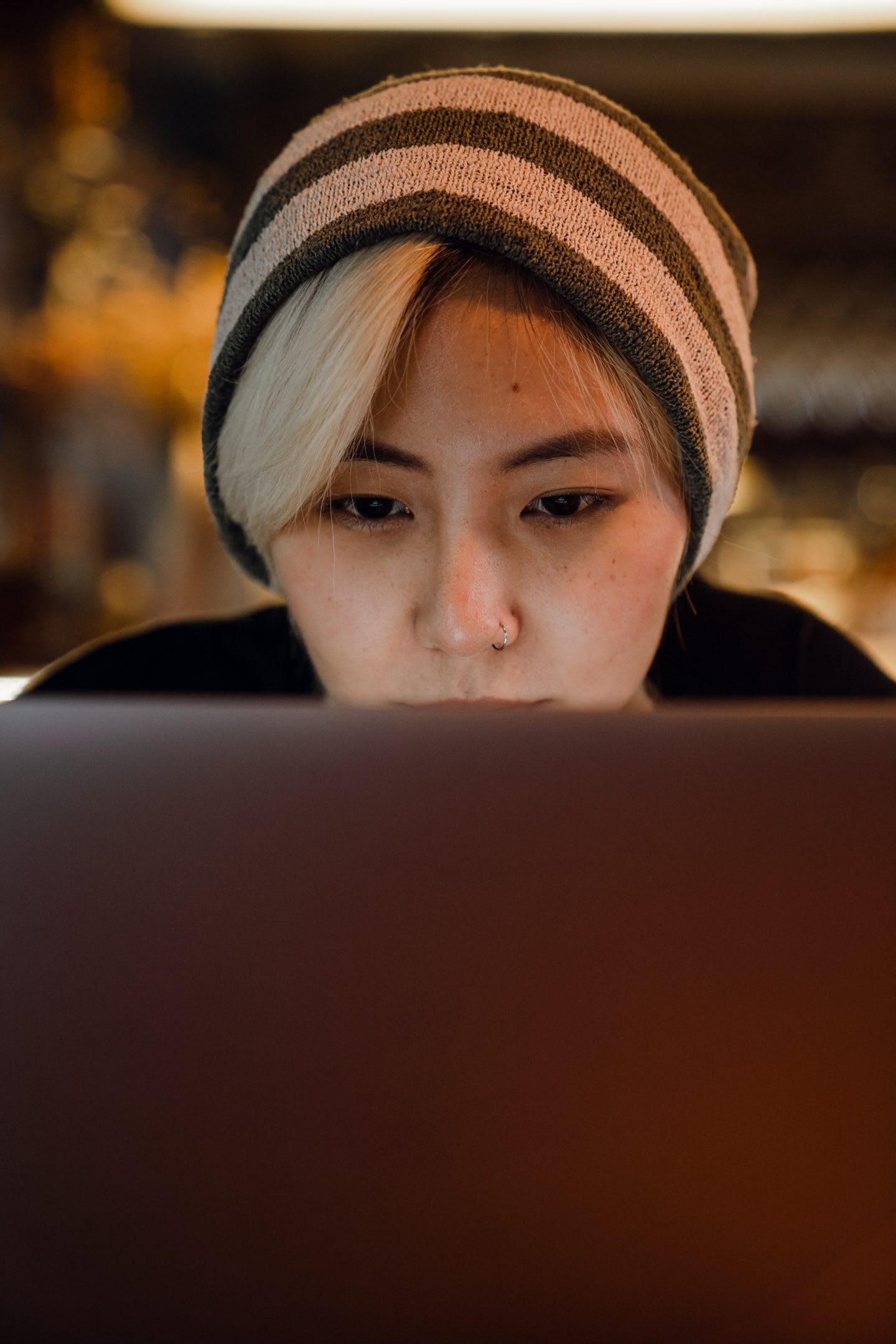 Woman working concentrated on laptop. Virtual meetings, home office, working remotely,