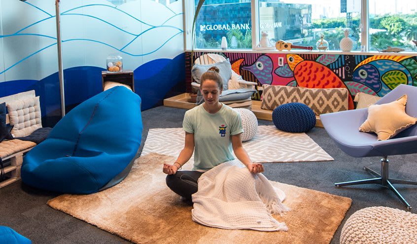 Woman sitting on a floor meditating, employee, adidas, Panama, workspace, worklife, oiffuce