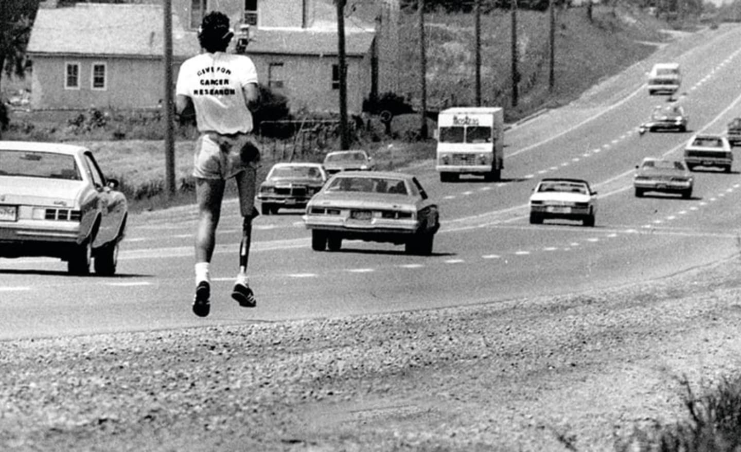 Black and white image of man with prosthetic leg running on road, Terry Fox, Canada, athlete, motivation, inspiration