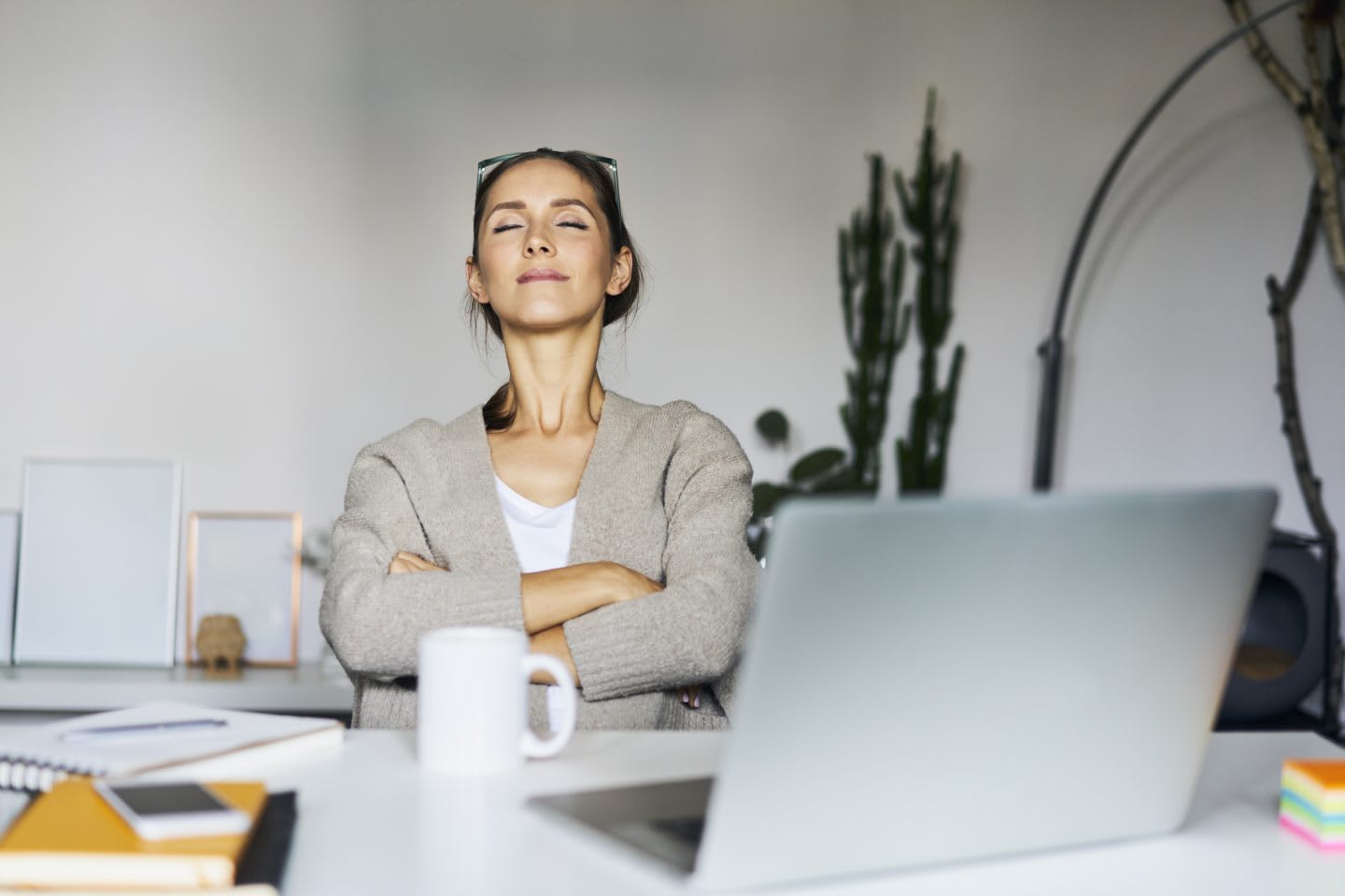 Young woman at home with laptop on desk having a break, work, breathing, stress