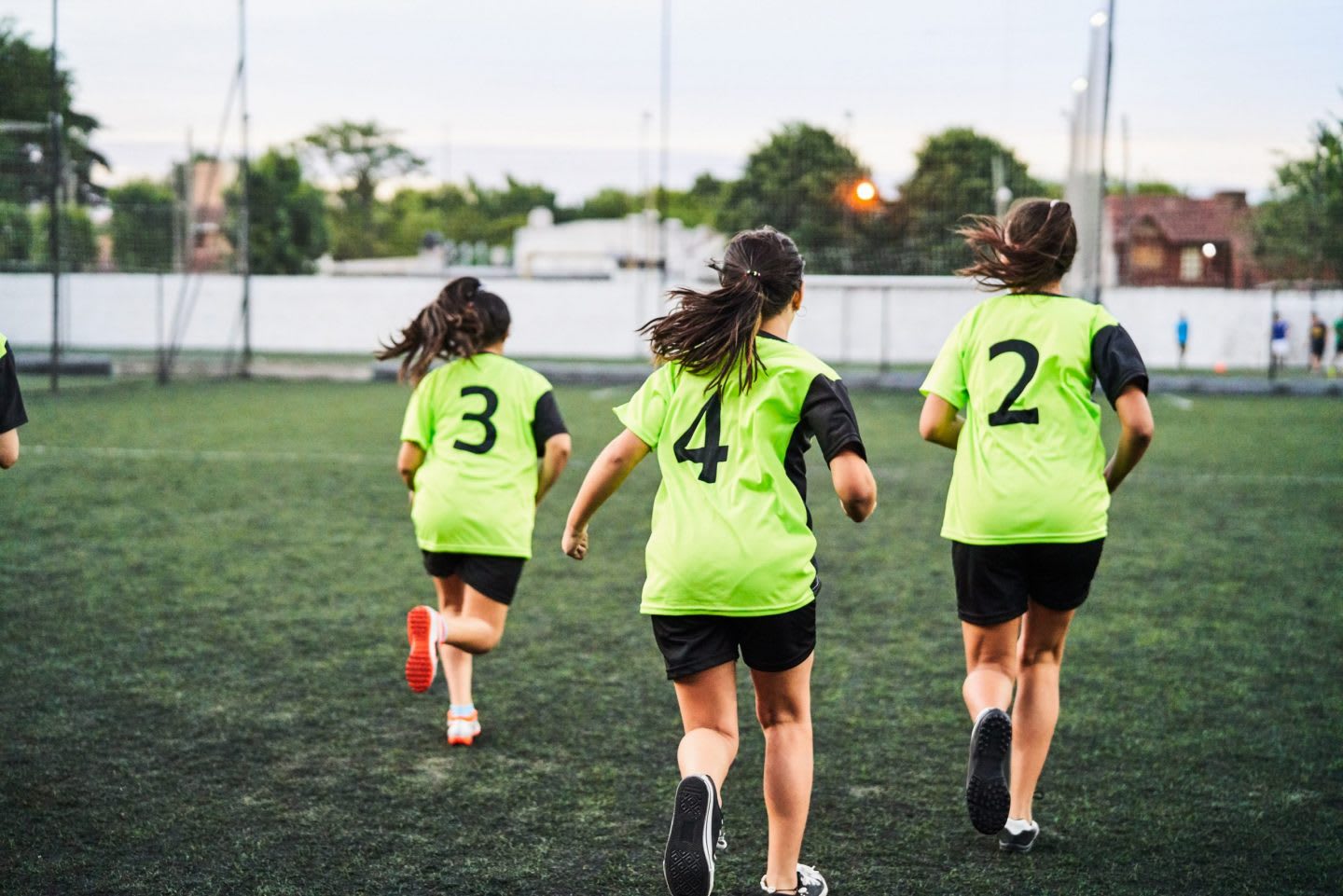girls playing football on the pitch