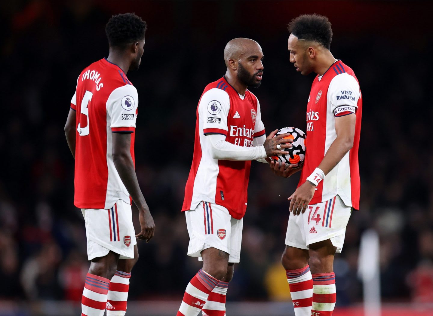 three football players on a pitch
