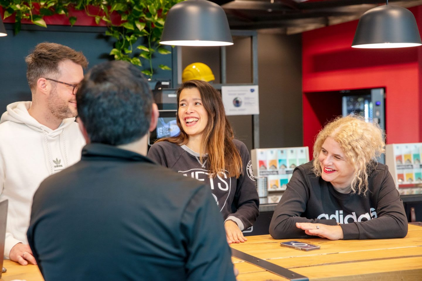 Robin chats with colleagues in the kitchen at adidas HQ.