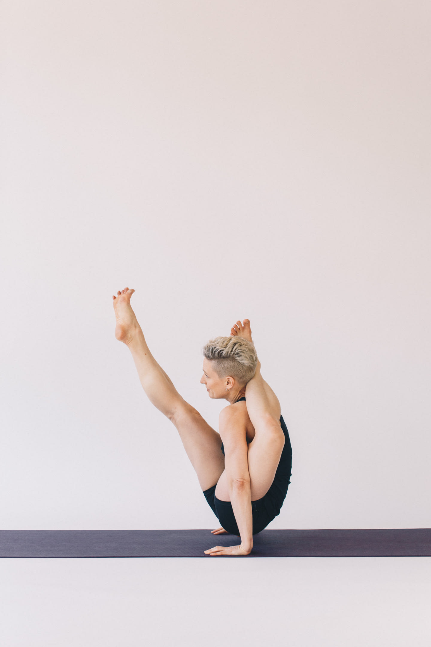 Woman performs yoga pose.
