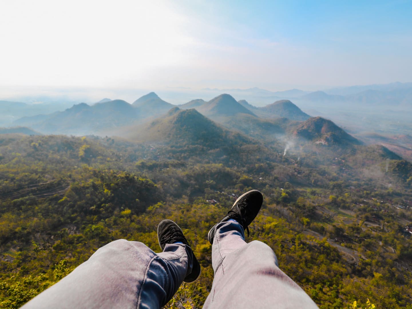 Person sitting on a ledge in beautiful nature setting