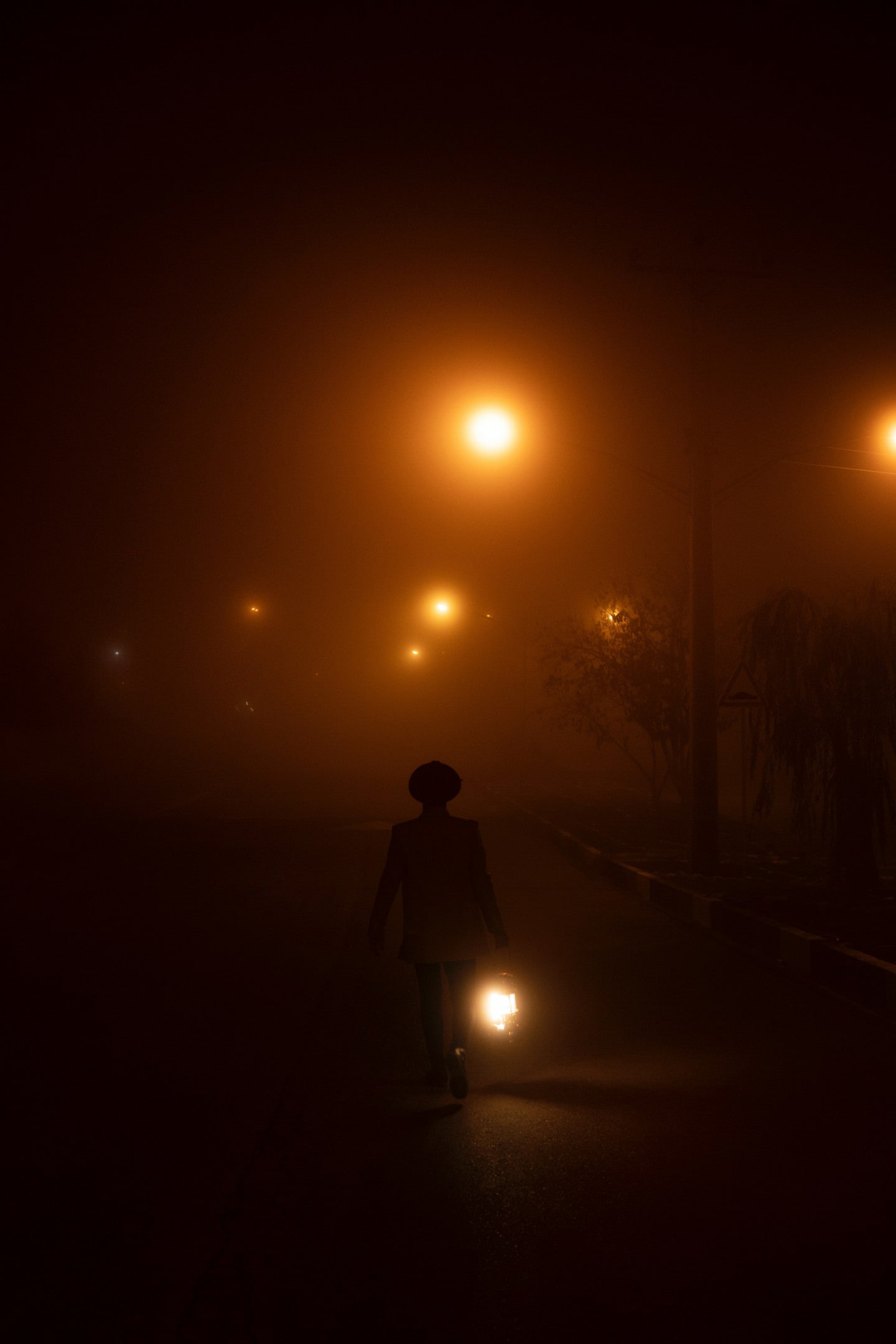 Person cycling through the night in foggy environment