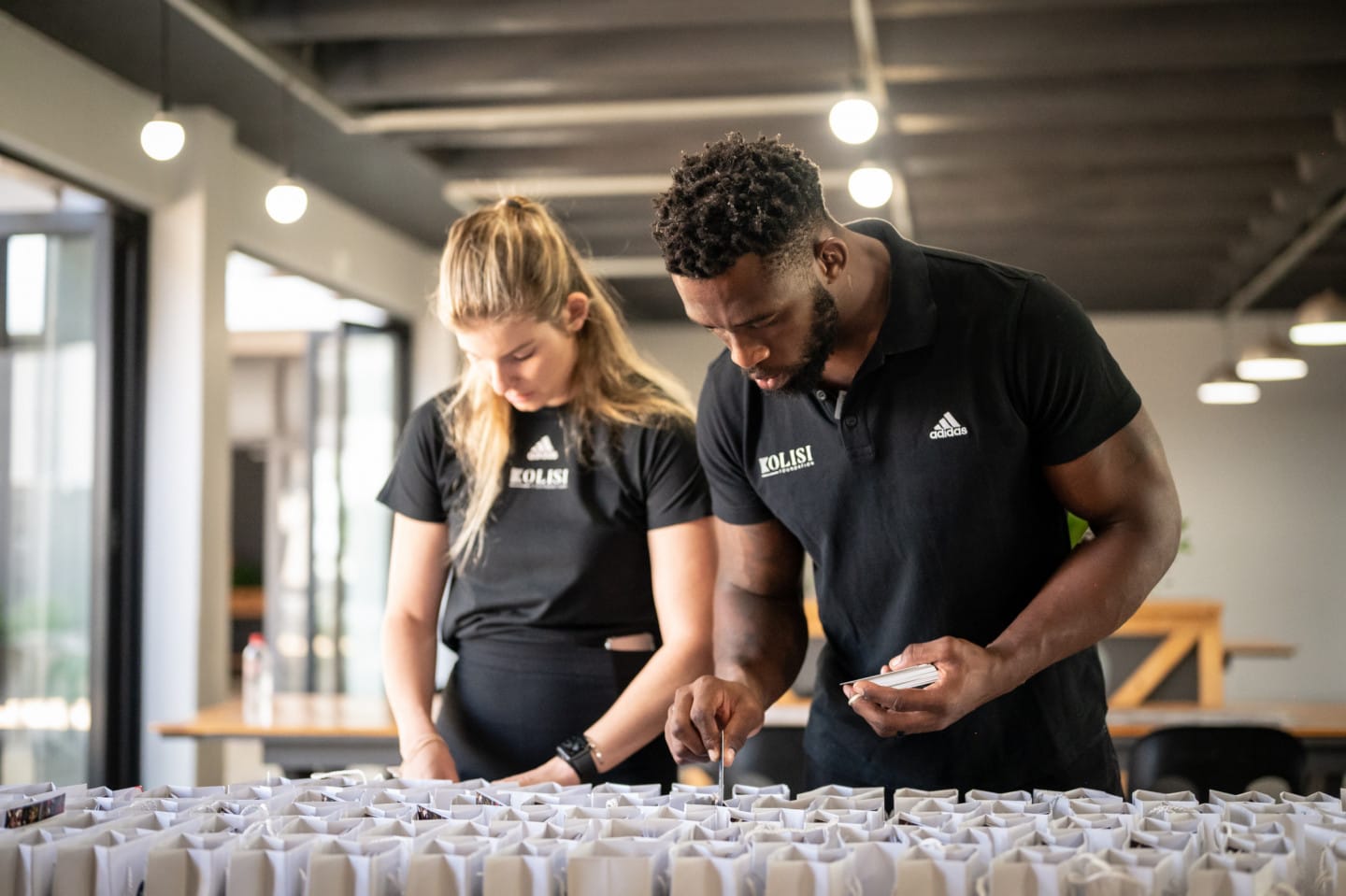 Siya and Rachel Kolisi prepare supplies for their foundation.