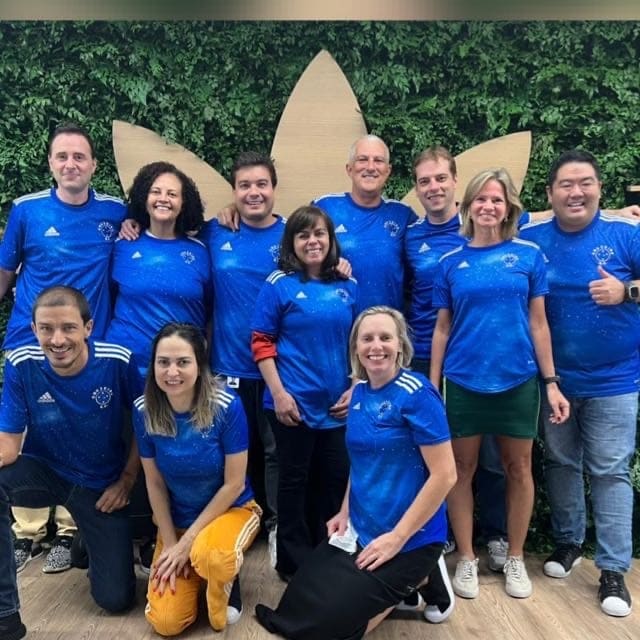 A team of adidas employees posed for a group shot in blue tshirts.