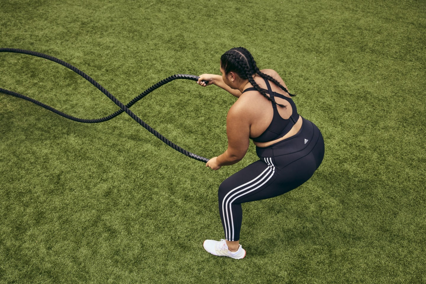Female athlete training using heavy ropes