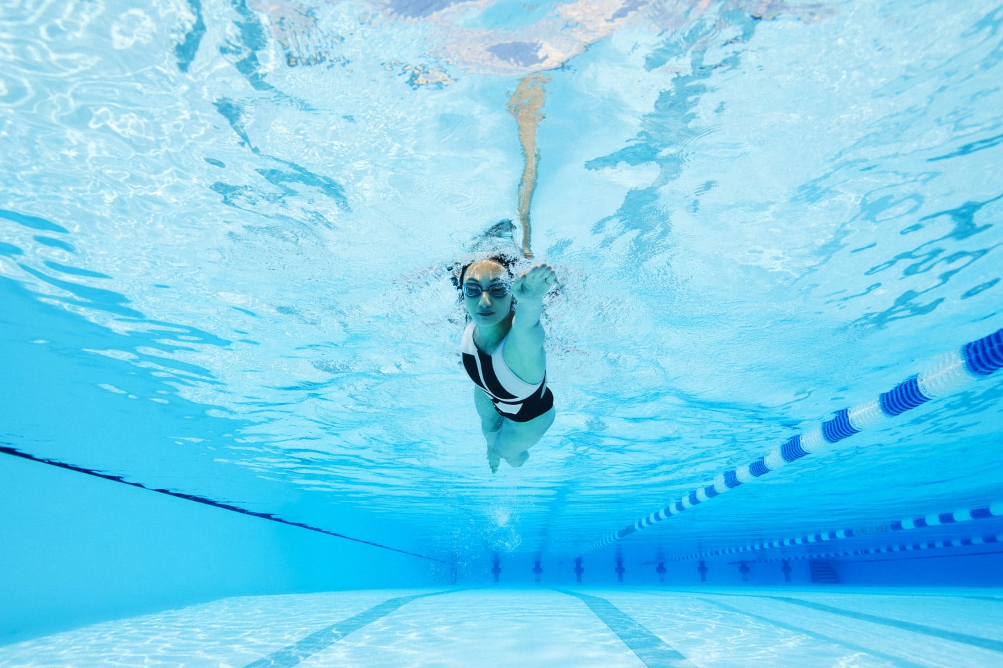 Person swimming in a pool adidas