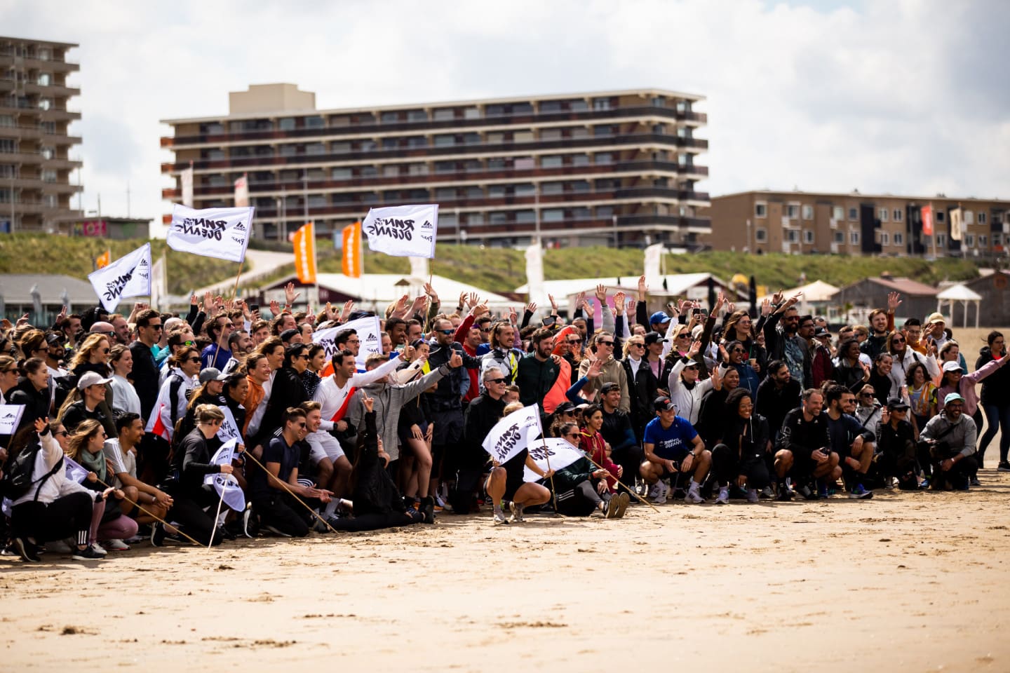 A large group of people posing for a picture on the beach