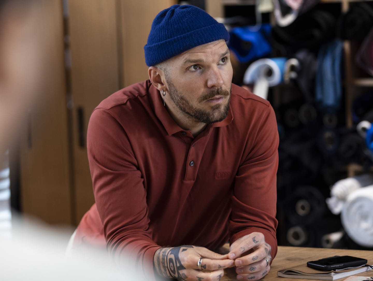 A man looks off into the distance with a look of concentration on his face.