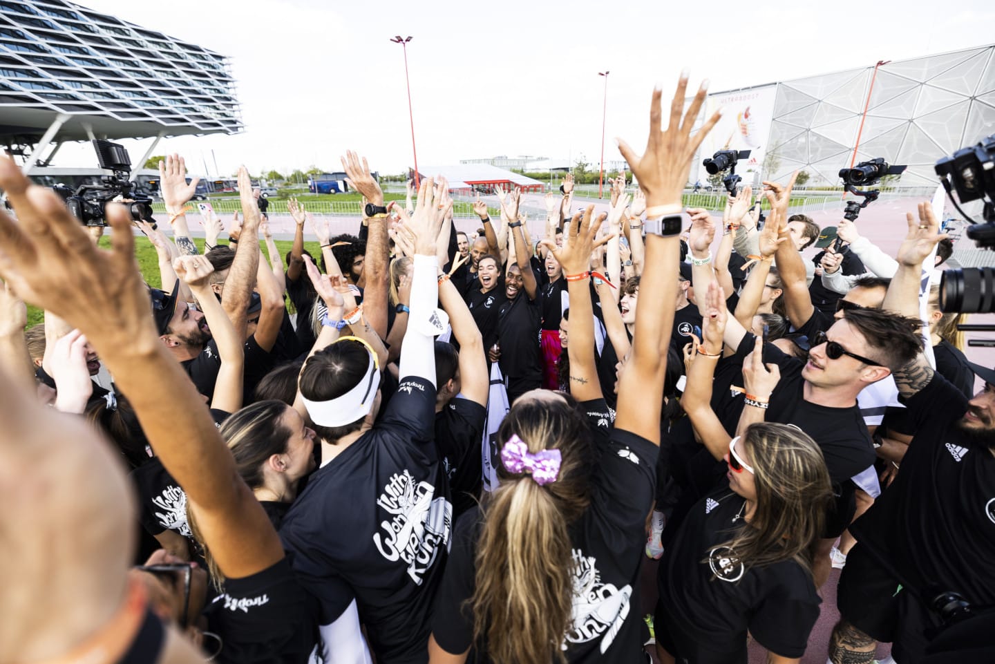 People coming together and raising their arms in the air