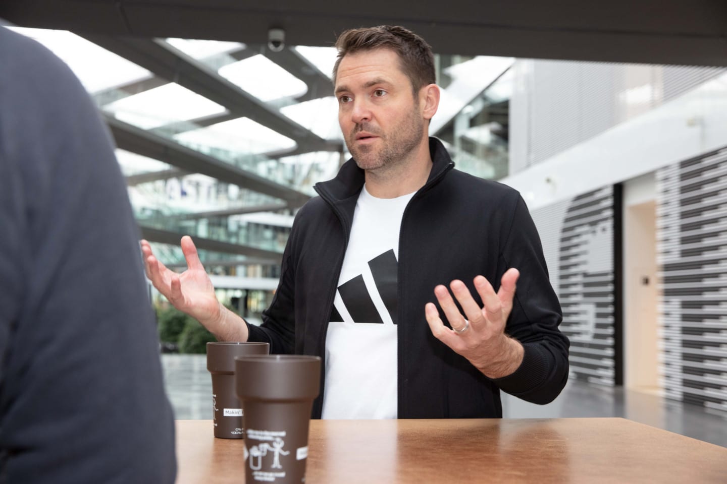 Man using hand gestures during a conversation at a table