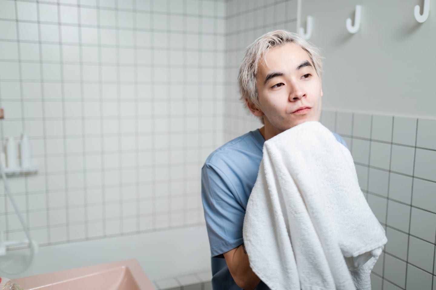 Man looking in the mirror while drying his face