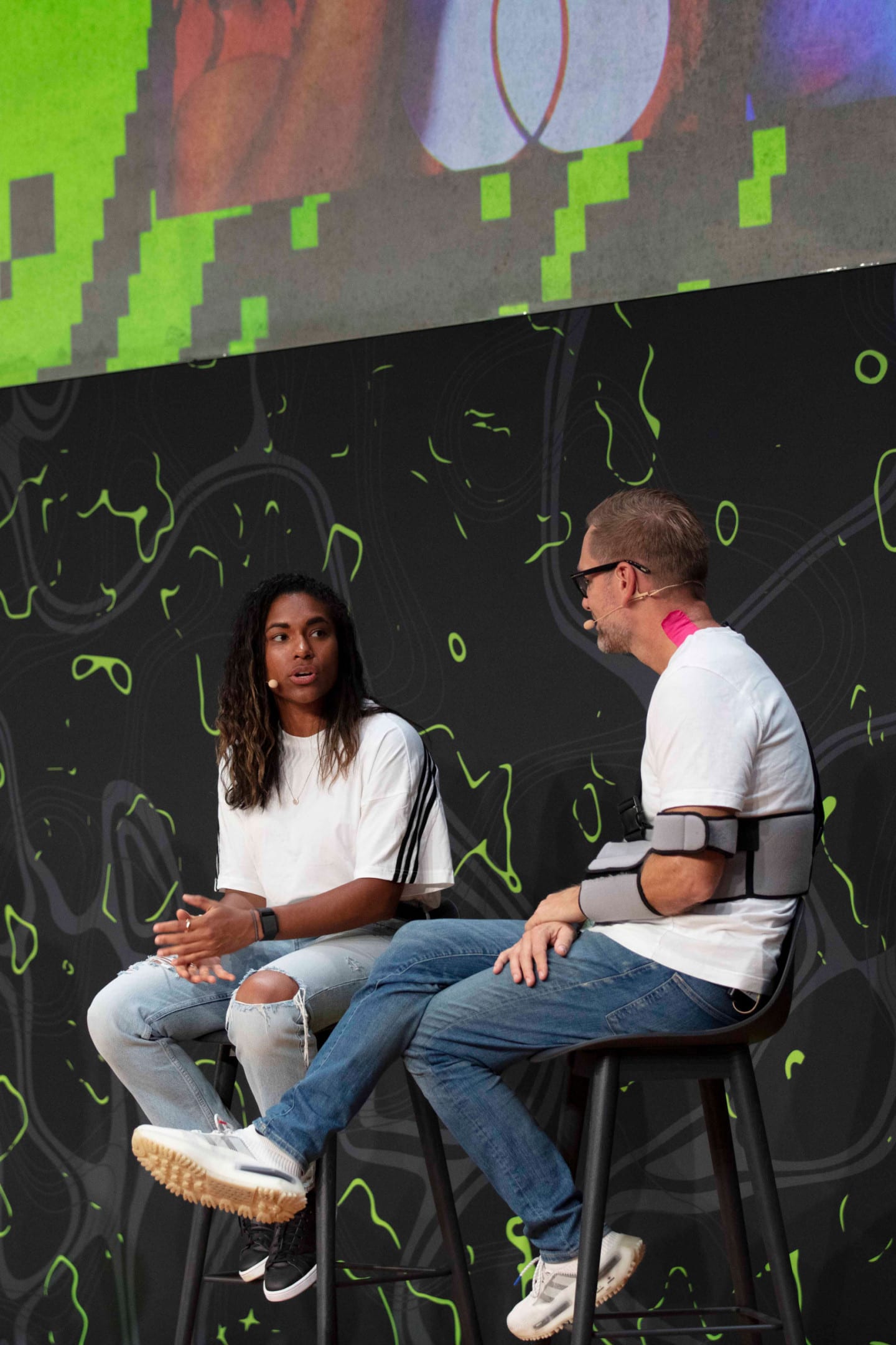 Woman sitting in a chair speaking to a man in a chair during an interview at adidas